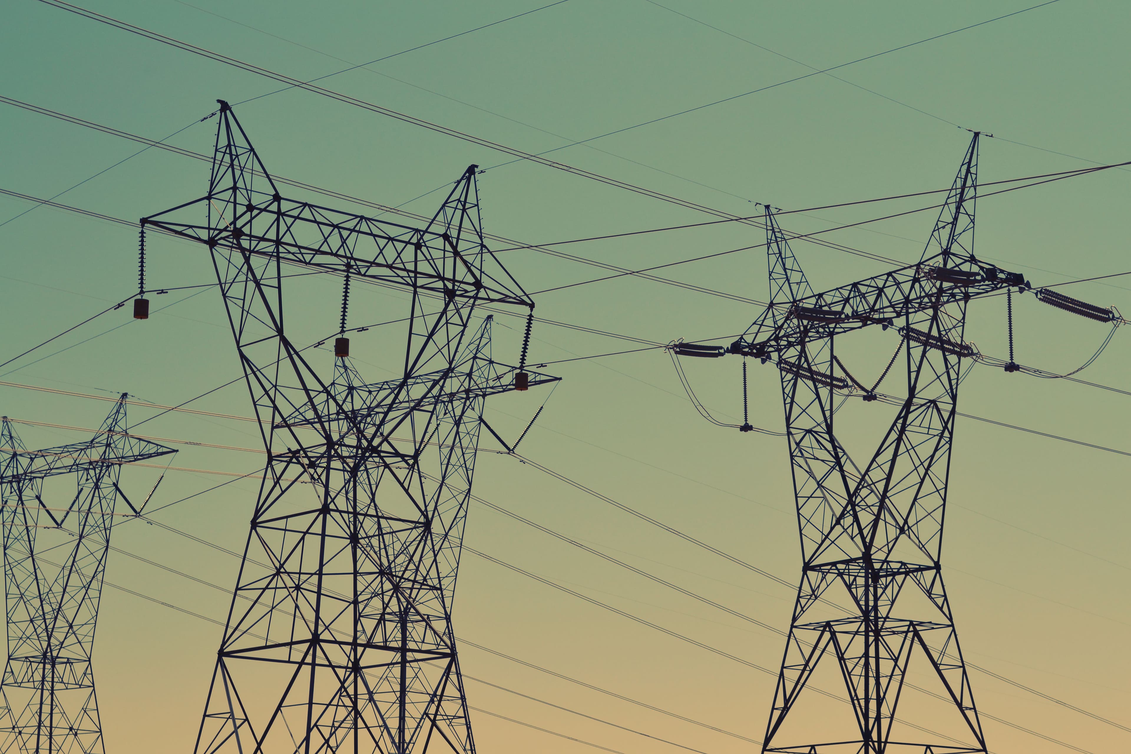 High-voltage transmission towers and power lines against the sky